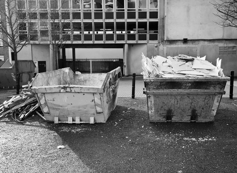 Construction site with builders clearing waste in Chiswick